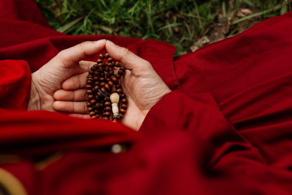 Person Holding Red and Black Beads